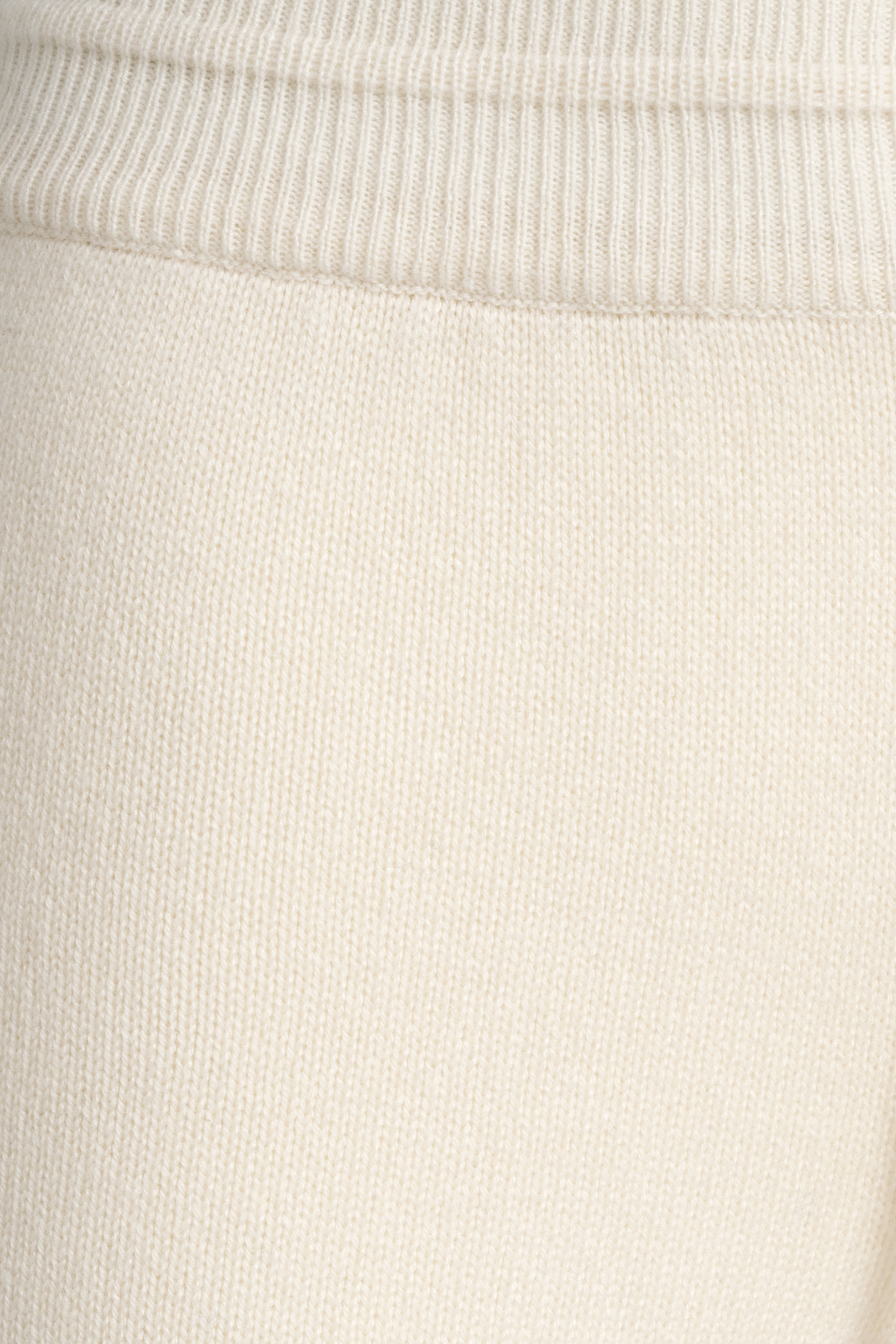 Close-up of The Verona Sweater in snow. Soft, fine texture in creamy white Cariaggi cashmere.

