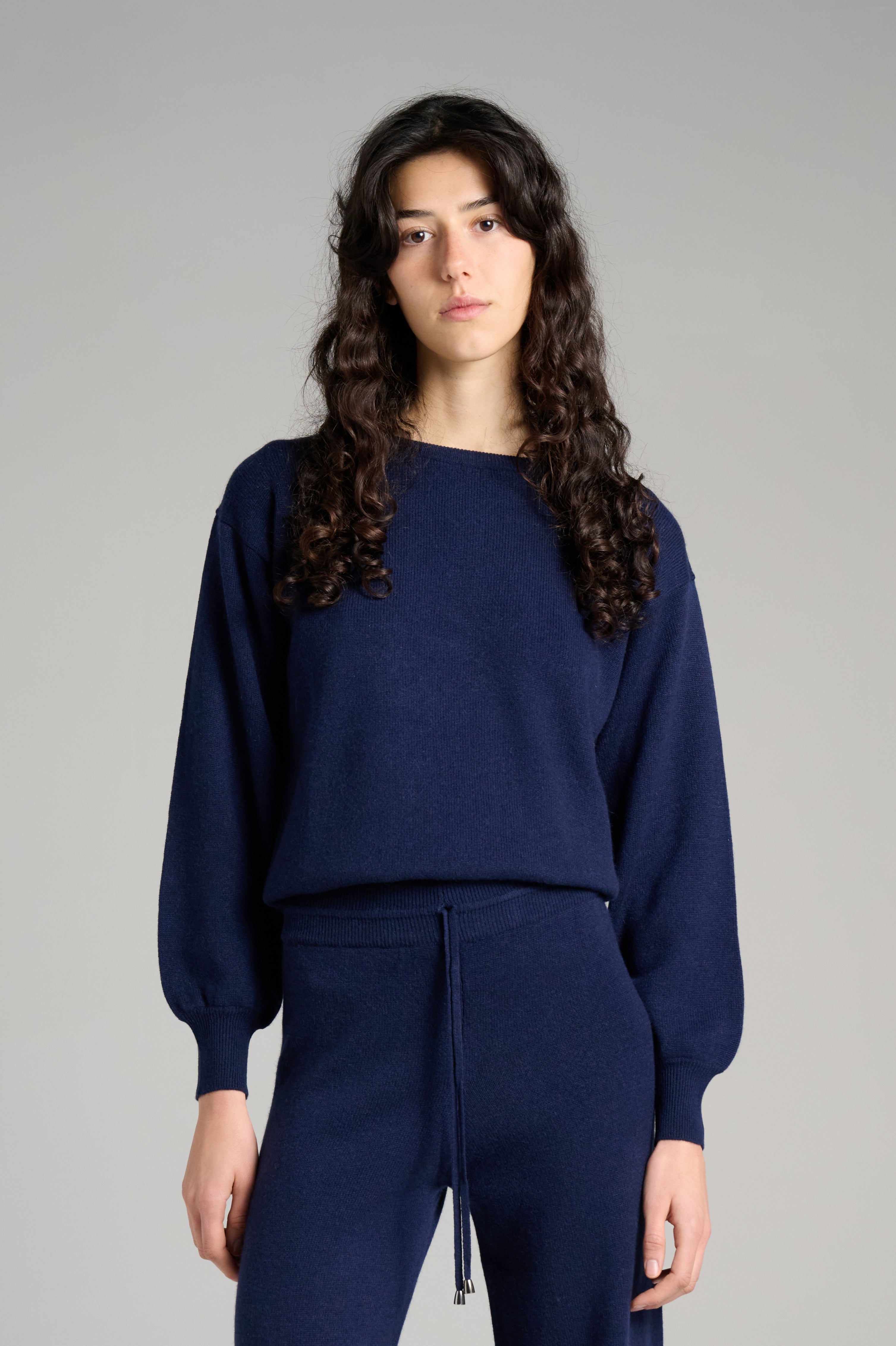 Model wearing Verona Sweater Navy Color – luxurious white cashmere sweater for women, crafted in Italy for ultimate softness, warmth, and sophisticated style.